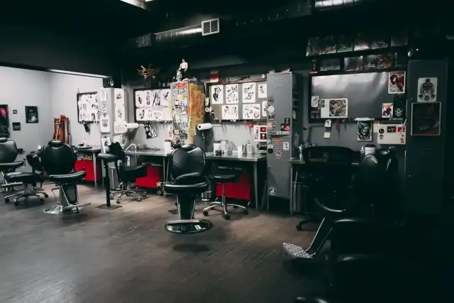 Tattoo artist working on a client in a professional studio